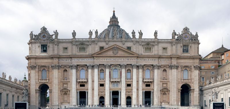 The facade of St. Peter's Basilica in Vatican City, daytime view from St. Peter's Square.