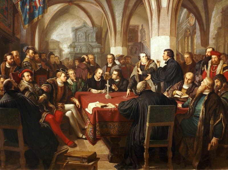 Painting by August Noack of the Marburg Colloquy of 1529, with Luther and Zwingli disputing across a table before assembled reformers.