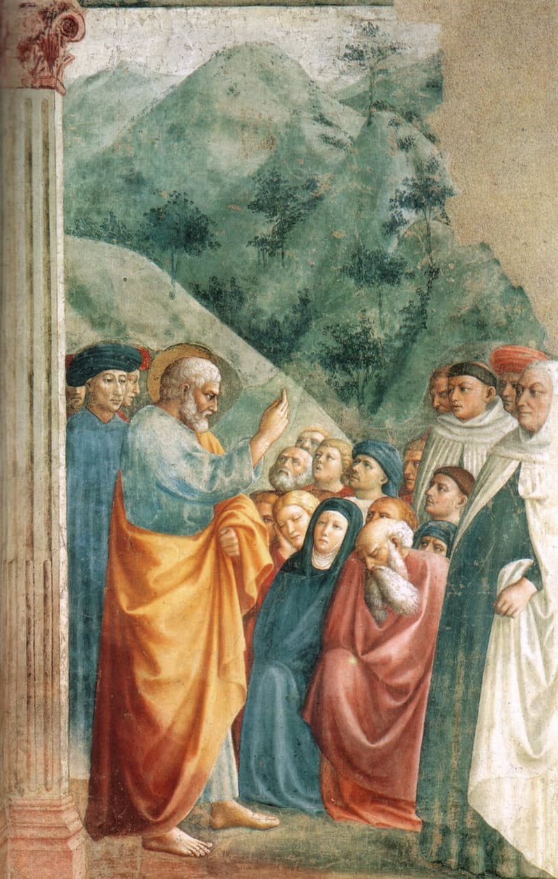Masolino's fresco of Saint Peter, haloed and wrapped in a golden-orange mantle, raising his hand as he preaches to a crowd of men and women gathered before green hills.