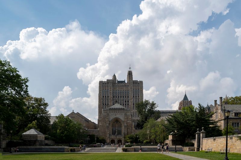 Yale University campus with Sterling Memorial Library under dramatic clouds—the start of a journey to Yale Divinity School