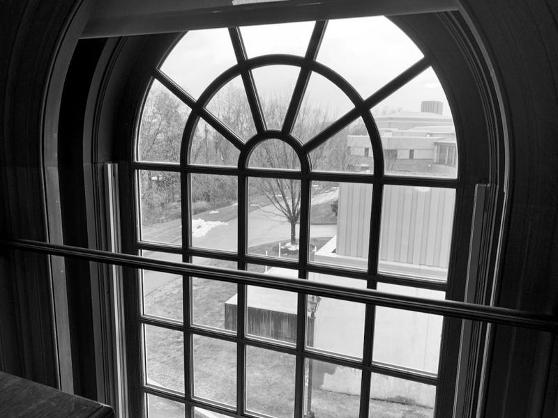 Arched institutional window with geometric lattice pattern, representing Yale Divinity School and academic reflection during first semester
