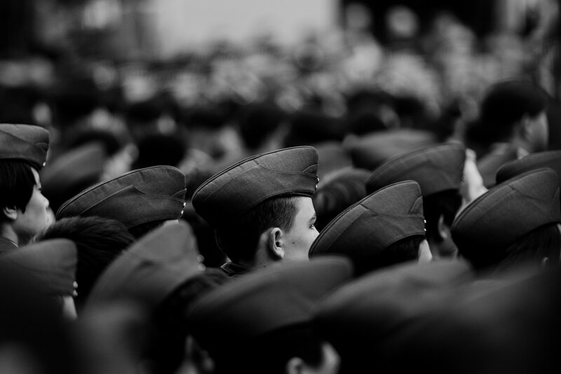 Rows of young Army cadets in dress caps awaiting commissioning