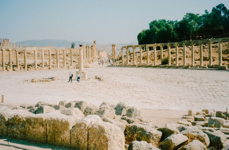 Ancient Roman ruins with stone columns in a semicircular forum, evoking the late Roman world of Augustine of Hippo and the North African church