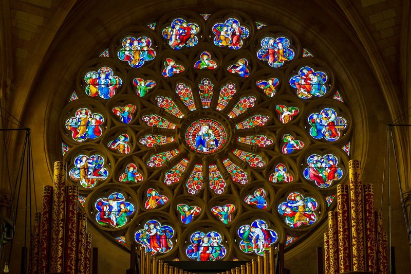 A cathedral rose window in brilliant stained glass, representing the Catholic interpretive tradition that reads Ruth typologically through the lens of Christ and the Church