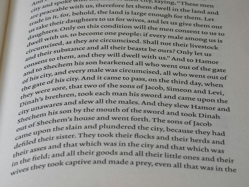 Close-up of a printed Bible page showing the narrative of Dinah, Shechem, and Hamor in Genesis 34, illustrating the kind of difficult Old Testament passage often raised in debates about biblical inerrancy