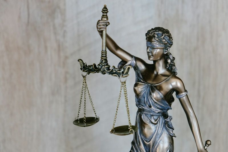 Bronze statue of Lady Justice holding scales, representing the legal craft taught at the Air Force Judge Advocate Staff Officer Course