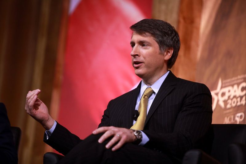 Rich Lowry speaking at a podium during a lecture on nationalism