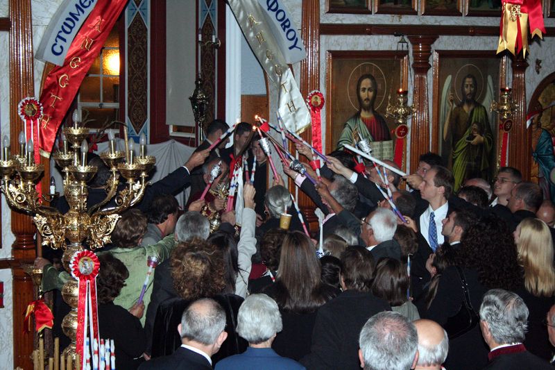 Orthodox faithful holding candles during the Paschal Vigil, celebrating the Resurrection of Christ at midnight.