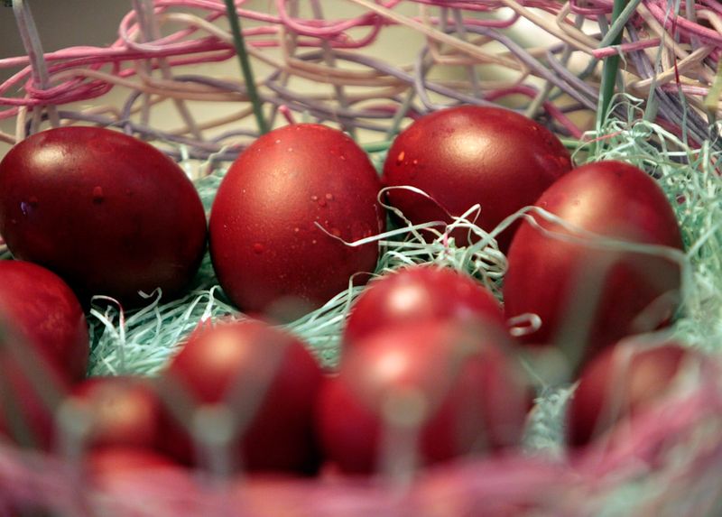Traditional red-dyed Orthodox Easter eggs in a basket, symbolizing the Resurrection of Christ
