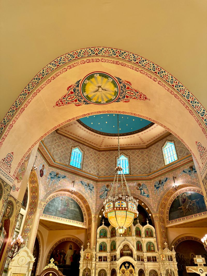 Interior of an Orthodox church with golden iconostasis contrasting with the simplicity of Protestant worship spaces.