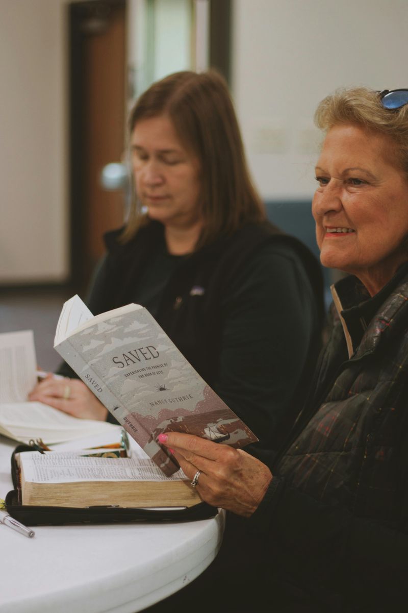 A group of women gathered around a table for Bible study, illustrating the importance of interpreting Scripture in community